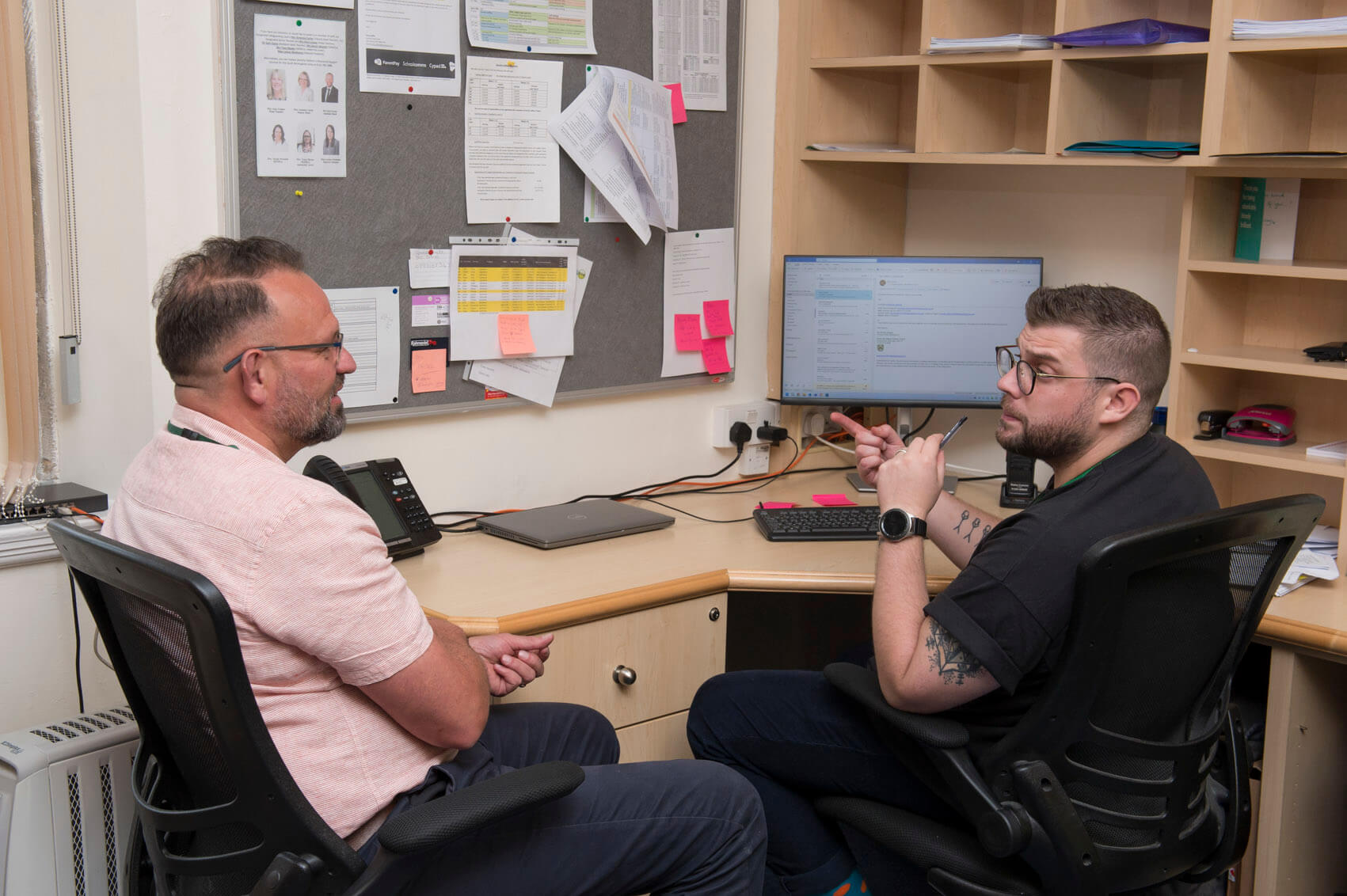 Two teachers talking in the staffroom